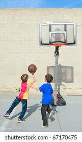 Two Boys Play Basketball