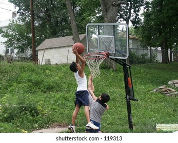 Two Boys Playing Basketball