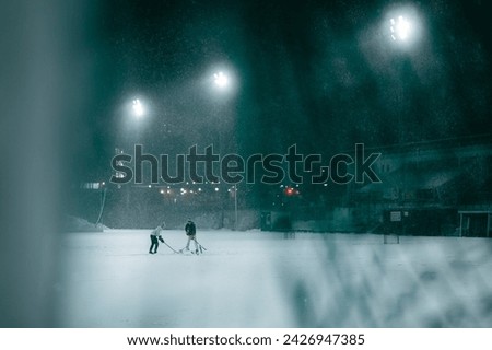 Two boys playing hockey in a stadium, Stockholm, Sweden