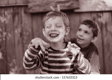 Two Boys Playing In The Summer Yard