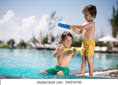 Two Boys Playing In The Swimming Pool