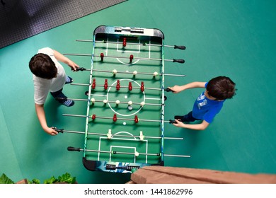 Two boys playing a tabletop Football  - Powered by Shutterstock