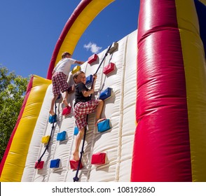 Two boys racing up balloon / inflatable climbing wall - Powered by Shutterstock