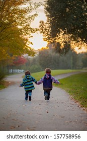 Two Boys, Running On A Pathway