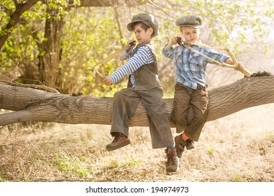 two-boys-sitting-on-tree-260nw-194974973