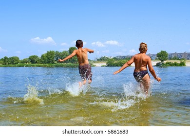 Two Boys, Slim And Fat, Run Into Water. Shot In June, Near Dnieper River, Ukraine.