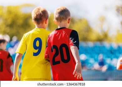 Two Boys Soccer Players In Colorful Jersey Shirts. Kids Children Compete In Sports Competition. Defensive Organization In Junior Youth Football Team