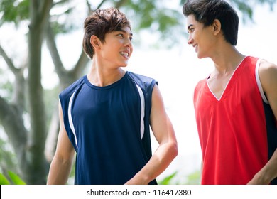 Two Boys In Sports Clothing Talking Outdoors