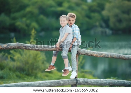 Two Boys Stand near Wooden Fence in Bavaria, Germany, Europe