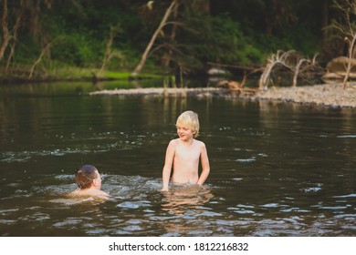 Two Boys Swimming In The Goulburn River, New South Wales Australia. Holiday Photos On Australian Road Trip.