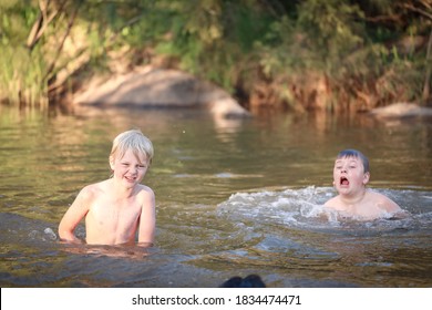 Two Boys Swimming In The Goulburn River, New South Wales Australia. Holiday Photos On Australian Road Trip.