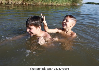 Two Boys Swimming In Lake, Krasnodar Region, Russia