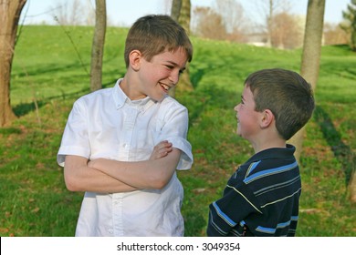 Two Boys Talking And Laughing In The Park