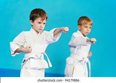 two boys training karate kata exercises at test qualification