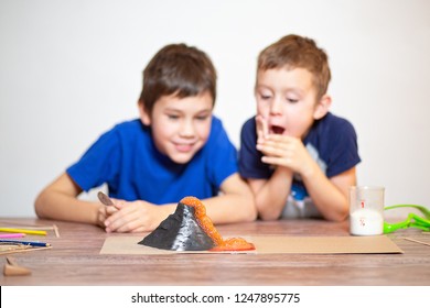 Two Boys Watching A Chemistry Experiment. Volcanic Eruption. School Science Project. Children Surprised. Chemical Reaction Of Baking Soda And Vinegar. Selective Focus