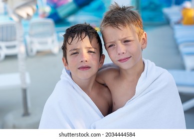 Two Boys Wrapped In A Bath Towel After Swimming In The Outdoor Pool.