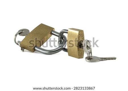 Two brass padlocks are securely chained together, each with a key inserted into its lock, representing protection and access