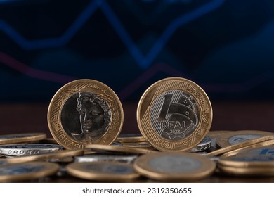 two brazilian coins in a pile of coins, BRL, simblo economy - Powered by Shutterstock