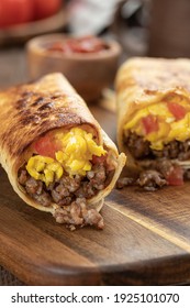 Two Breakfast Burritos With Scrambled Egg, Sausage And Tomato In A Tortilla Wrap