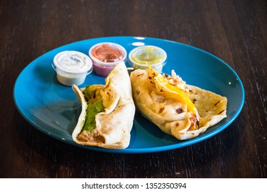 Two Breakfast Tacos With Salsa On Blue Plate , Tex Mex Food Inspired By Mexican Cuisine