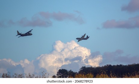 Two British RAF Lockheed Martin C-130J Hercules aircraft on military exercise cargo parachute drop run over Salisbury Plain Training Area, UK
