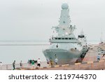 Two British warships doing training in harbour, some random people strolling around near ship. Sea. Water. Radar. UK. United Kingdom. Port