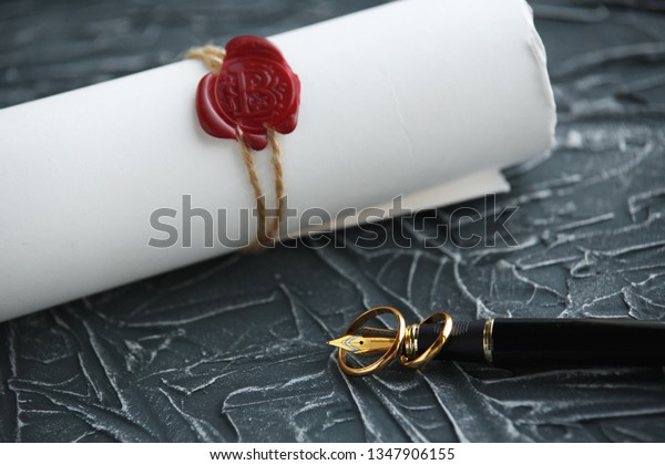 Two broken golden wedding rings\
divorce decree document. Divorce and separation\
concept