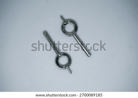 two broken handcuff keys on a white background