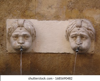 Two Brother Statues Fontain With Curious Faces Spit Water In The Roman Area Of Aix En Provence