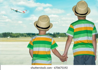 Two Brothers At The Airport Watching The Plane Taking Off.