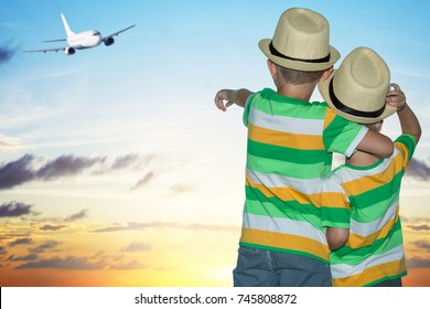  Two Brothers At The Airport Watching The Plane Taking Off.