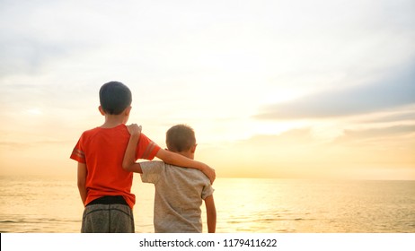 Two brothers enjoying sunset view at the seaside. Additional grains effect to create mood. - Shutterstock ID 1179411622