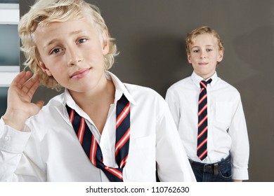 Two Brothers Getting Ready For School At Home, Wearing Uniform Shirts And Ties.