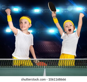Two brothers play ping-pong.The joy of victory.