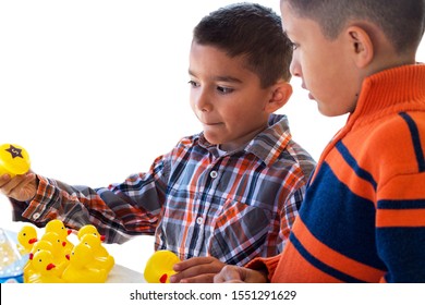 Two Brothers Playing A Carnival Game With Floating Ducks