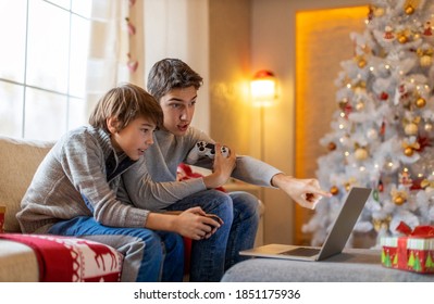 Two Brothers Playing Computer Games At Christmas Time
