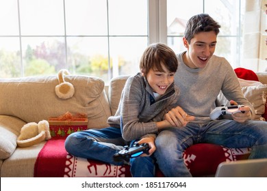 Two Brothers Playing Computer Games At Christmas Time
