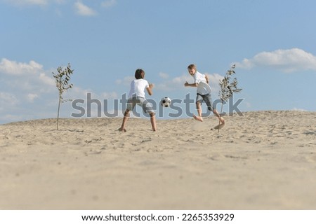 Similar – Image, Stock Photo Three generations female playing soccer on the beach