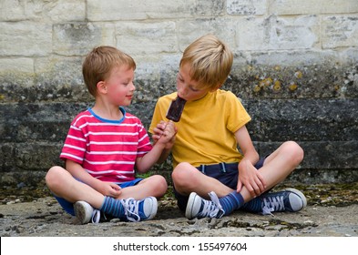 Two Brothers Sharing An Ice Lolly