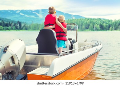 Two Brothers Swim On A Motor Boat On The Lake.	