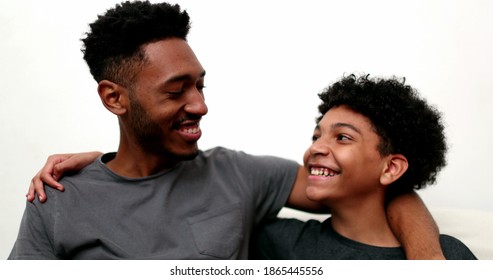 Two brothers together smiling. Black mixed race siblings, older and younger brother - Shutterstock ID 1865445556