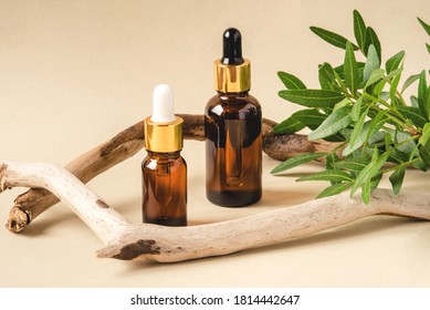 Two Brown Bottles Of Cosmetics On A Beige Background. Natural Driftwood Decor. Front View.