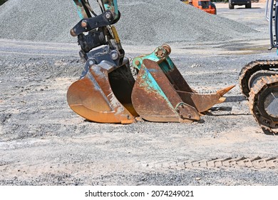 Two Buckets On The Front Of A Small Digger