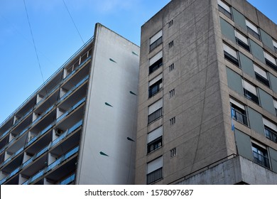 Two buildings in parallel with nice shadow between them.