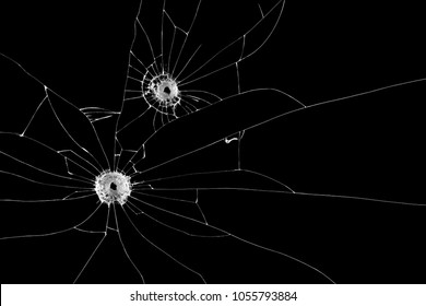Two bullet holes on window isolated on black background. 