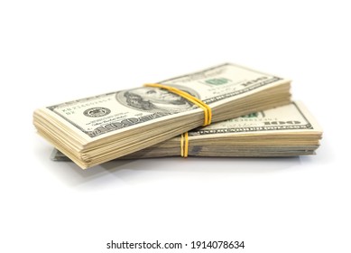 two bundles of one hundred dollar bills tied with an elastic band, isolated on a white background.
