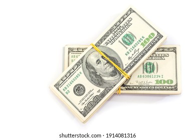 two bundles of one hundred dollar bills tied with an elastic band, isolated on a white background.View from above. Copy space.