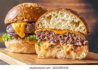 Two burgers on the wooden board close up - Powered by Shutterstock