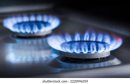 two burning gas burners on a kitchen gas stove - Shutterstock ID 2220996359