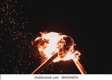 two burning torches on a dark background, smoke and fire from burning torches.